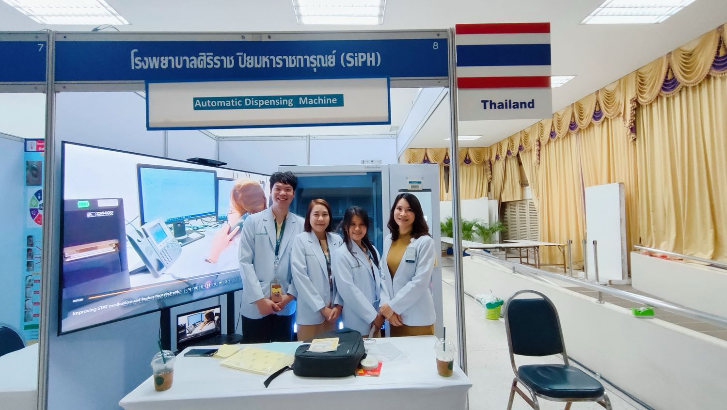Medical team from Siriraj Piyamaharajgarun Hospital presenting an automatic dispensing machine at a healthcare exhibition in Thailand